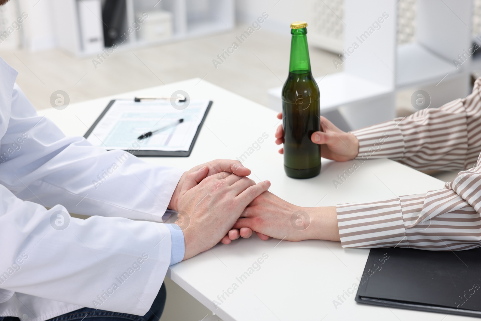 Photo of Alcoholic woman having appointment with healthcare specialist in clinic, closeup. Addiction treatment