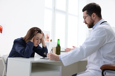 Photo of Alcoholic woman having appointment with healthcare specialist in clinic. Addiction treatment