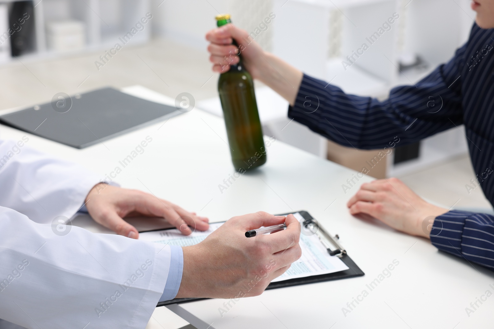 Photo of Alcoholic woman having appointment with healthcare specialist in clinic, closeup. Addiction treatment