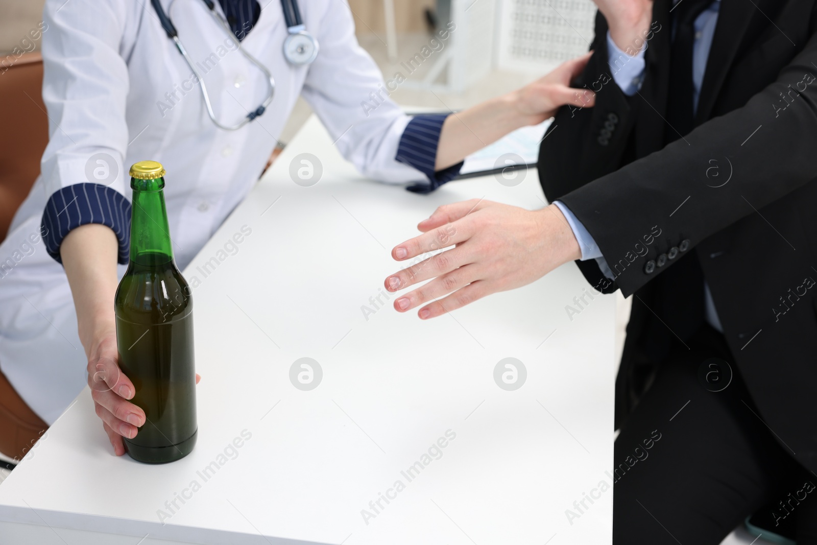 Photo of Alcoholic man having appointment with healthcare specialist in clinic, closeup. Addiction treatment