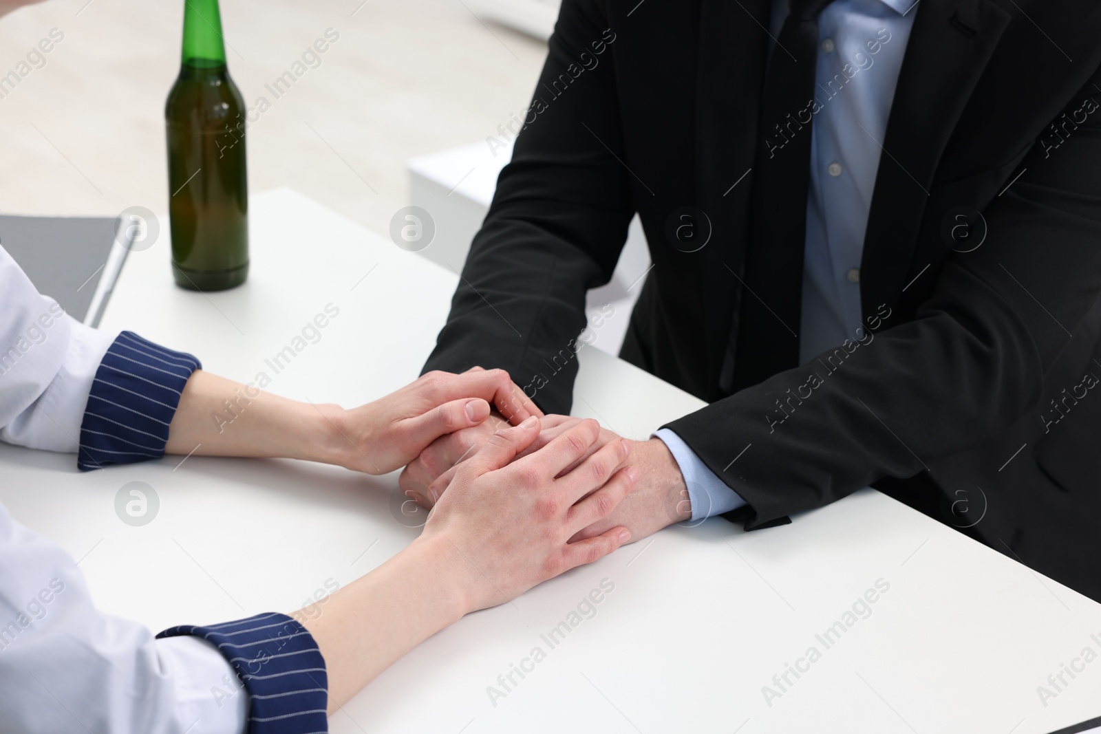 Photo of Alcoholic man having appointment with healthcare specialist in clinic, closeup. Addiction treatment