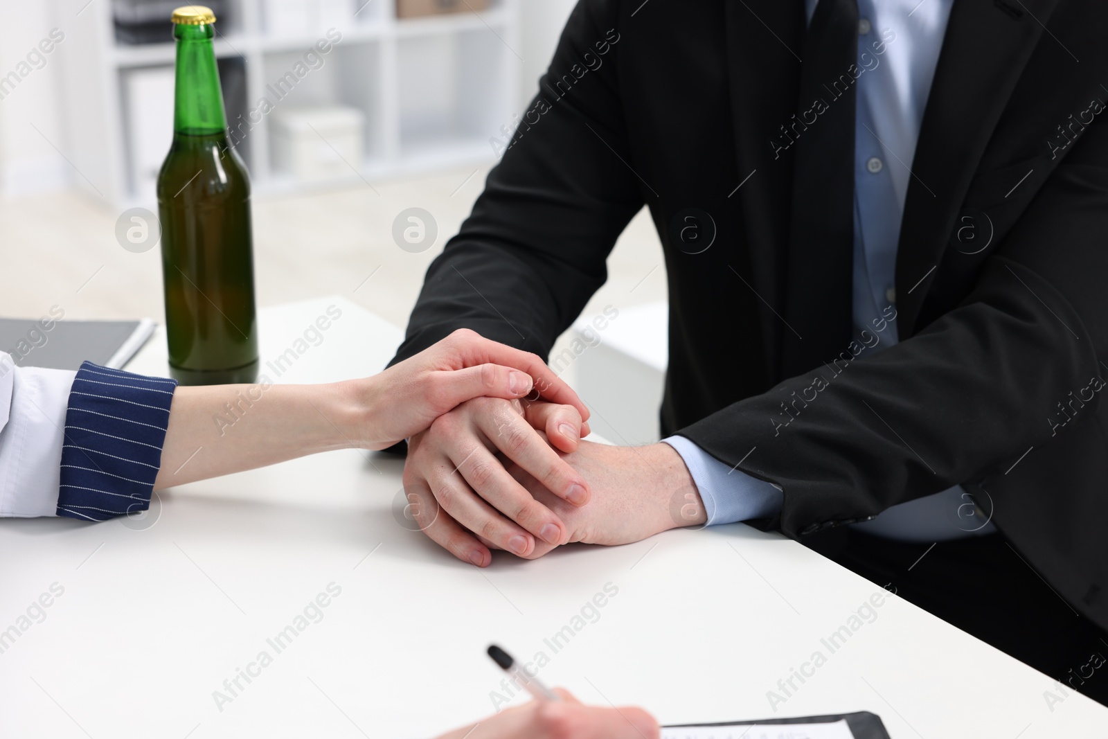 Photo of Alcoholic man having appointment with healthcare specialist in clinic, closeup. Addiction treatment