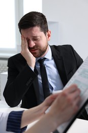 Photo of Alcoholic man having appointment with healthcare specialist in clinic. Addiction treatment