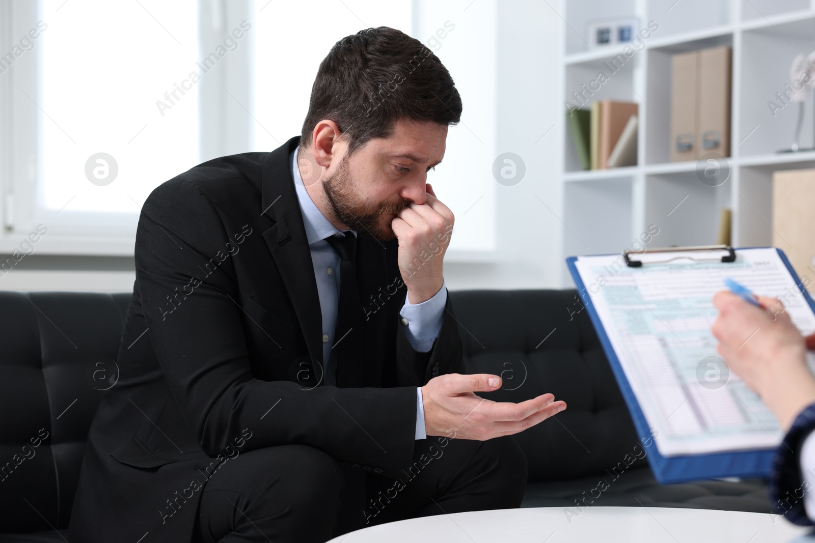 Photo of Alcoholic man having appointment with healthcare specialist in clinic. Addiction treatment