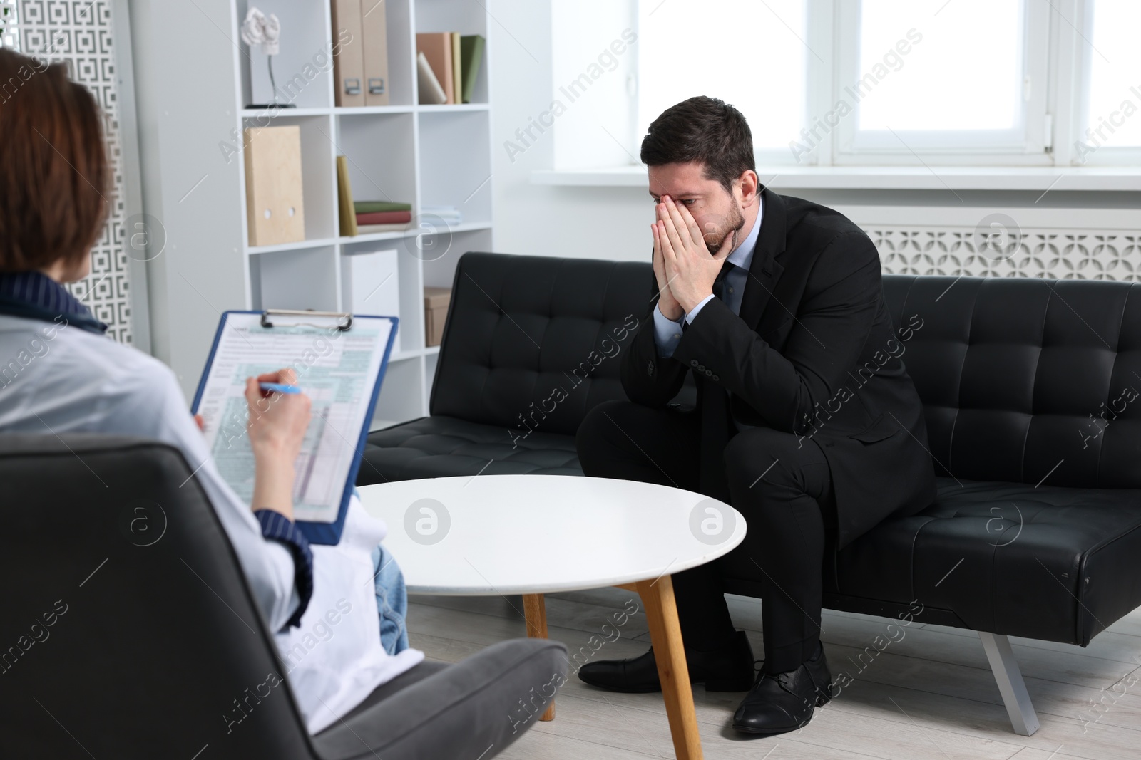 Photo of Alcoholic man having appointment with healthcare specialist in clinic. Addiction treatment