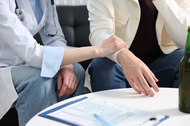 Photo of Dependent man having appointment with addiction specialist in clinic, closeup