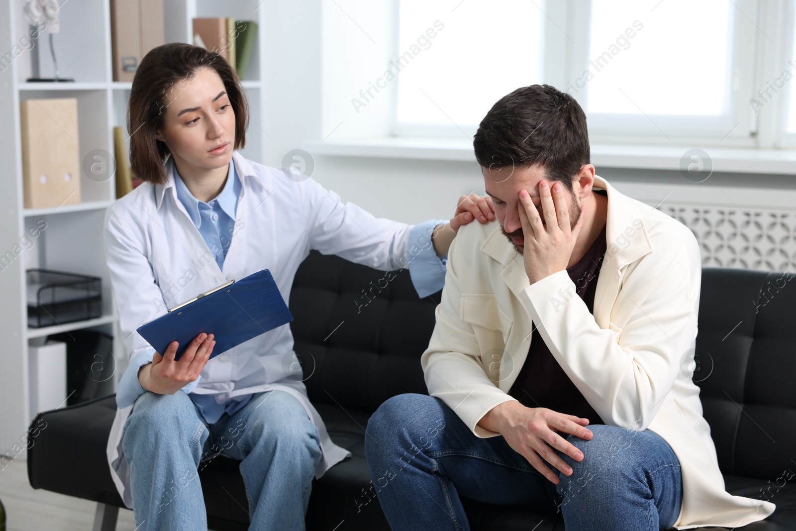 Photo of Alcoholic man having appointment with healthcare specialist in clinic. Addiction treatment