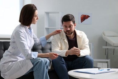 Photo of Alcoholic man having appointment with healthcare specialist in clinic. Addiction treatment