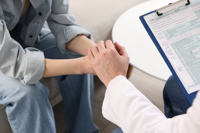 Photo of Dependent woman having appointment with addiction specialist in clinic, closeup