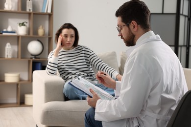 Photo of Alcoholic woman having appointment with healthcare specialist in clinic, selective focus. Addiction treatment