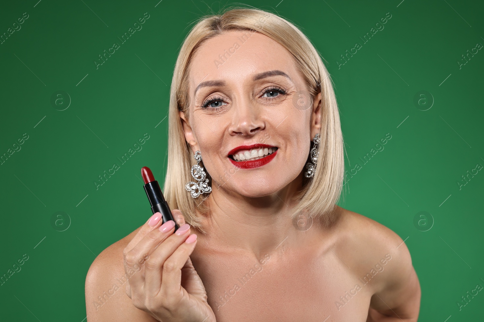 Photo of Smiling woman with red lipstick on green background