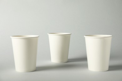 Photo of Paper cups on grey background. Mockup for design