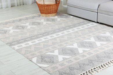 Photo of Stylish soft rug with pattern on floor in living room
