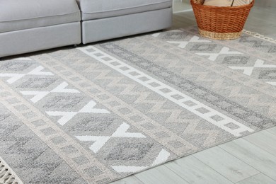 Photo of Stylish soft rug with pattern on floor in living room