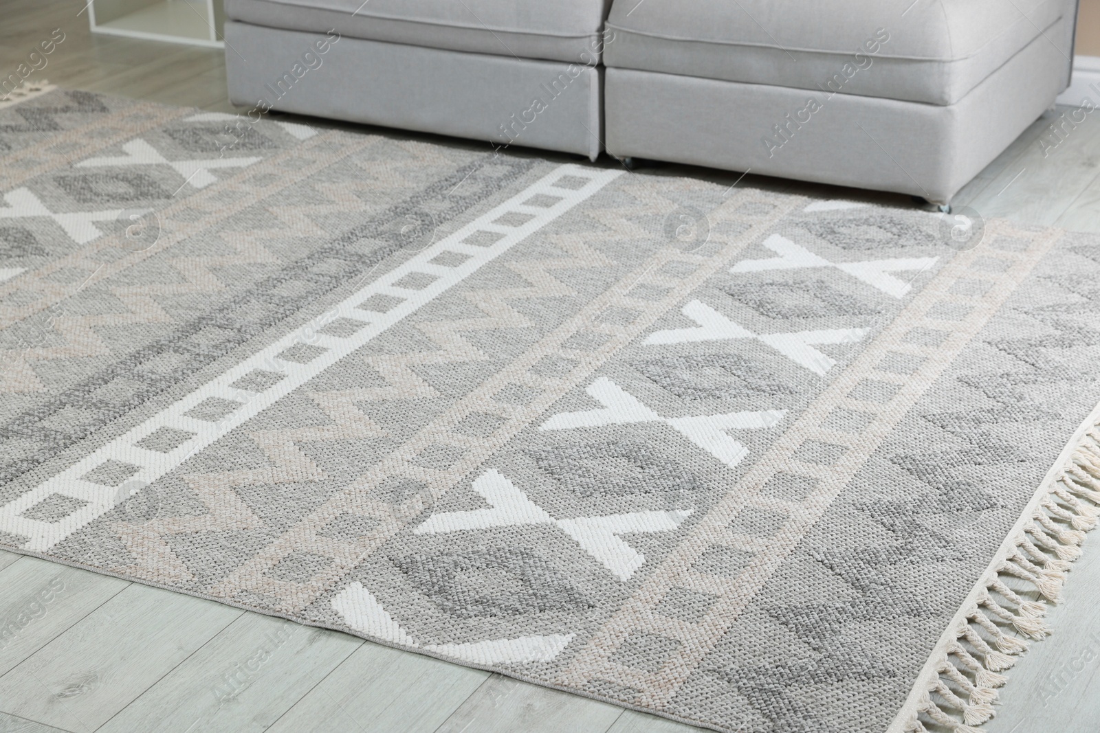 Stylish soft rug with pattern on floor in living room Photo of Stylish soft rug with pattern on floor in living room