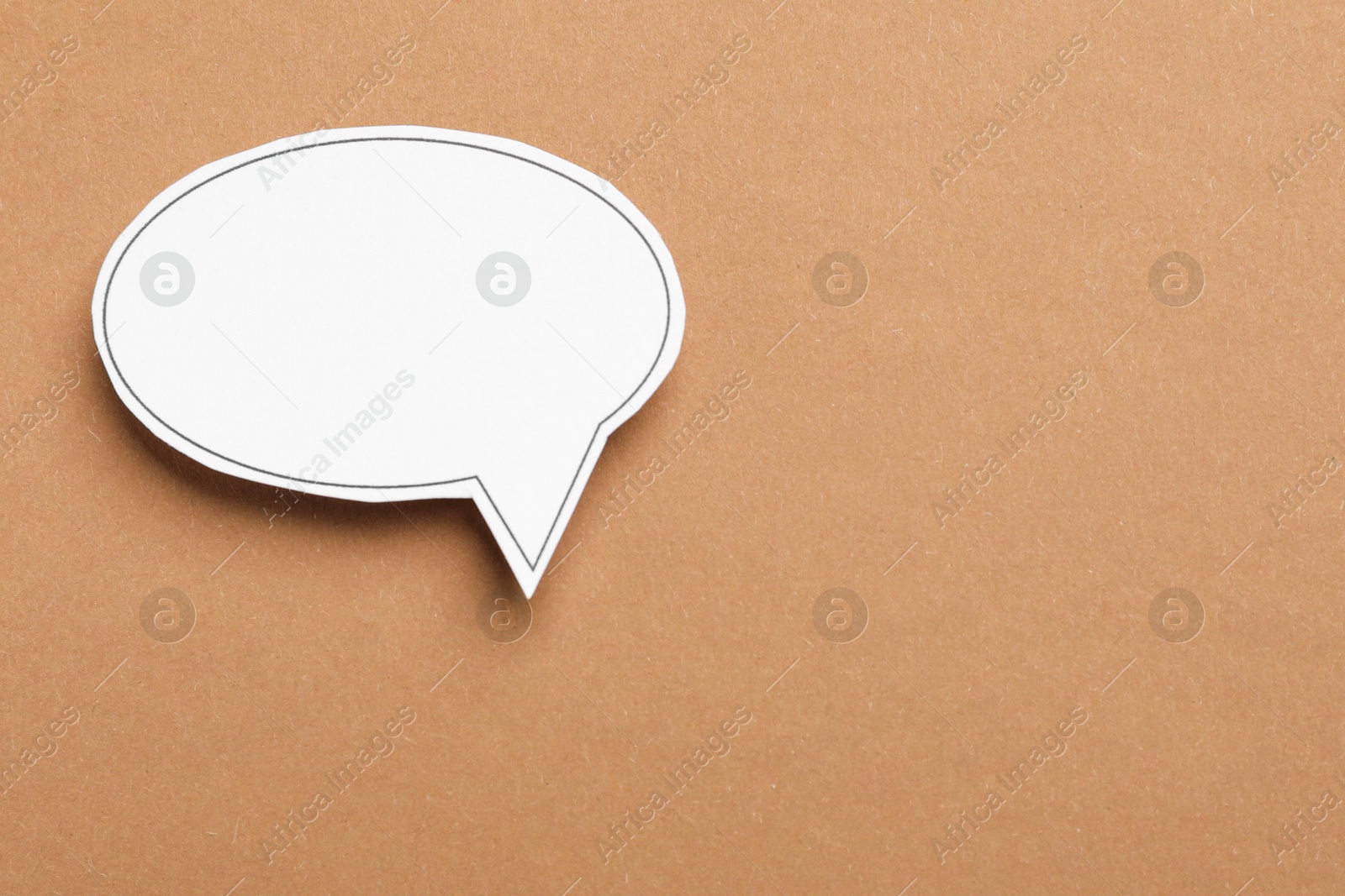 Photo of Blank speech bubble on brown background. Space for text