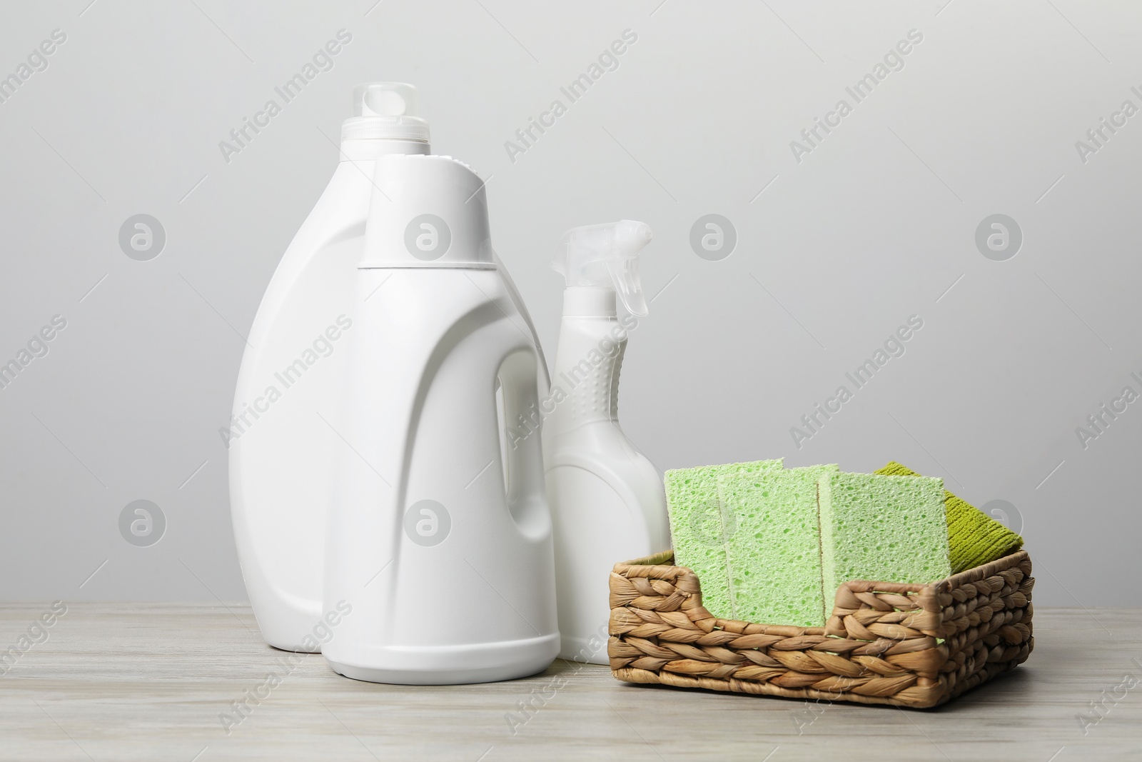 Photo of Eco-friendly cleaning products and supplies on wooden table