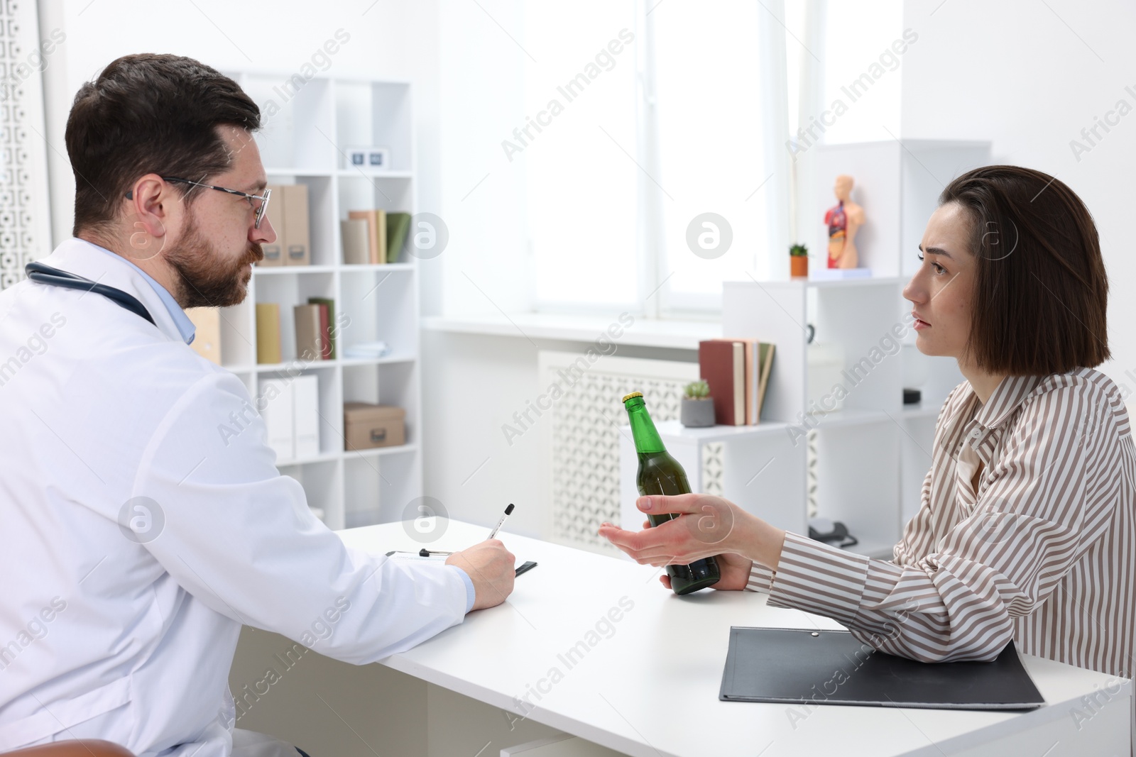 Photo of Alcoholic woman having appointment with healthcare specialist in clinic. Addiction treatment