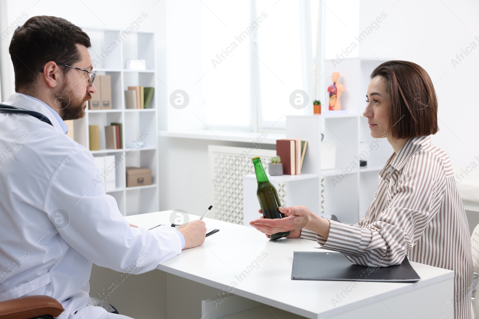 Photo of Alcoholic woman having appointment with healthcare specialist in clinic. Addiction treatment