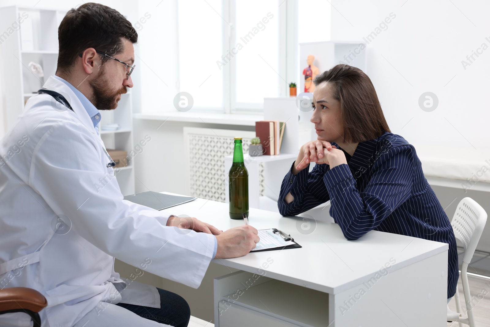 Photo of Alcoholic woman having appointment with healthcare specialist in clinic. Addiction treatment