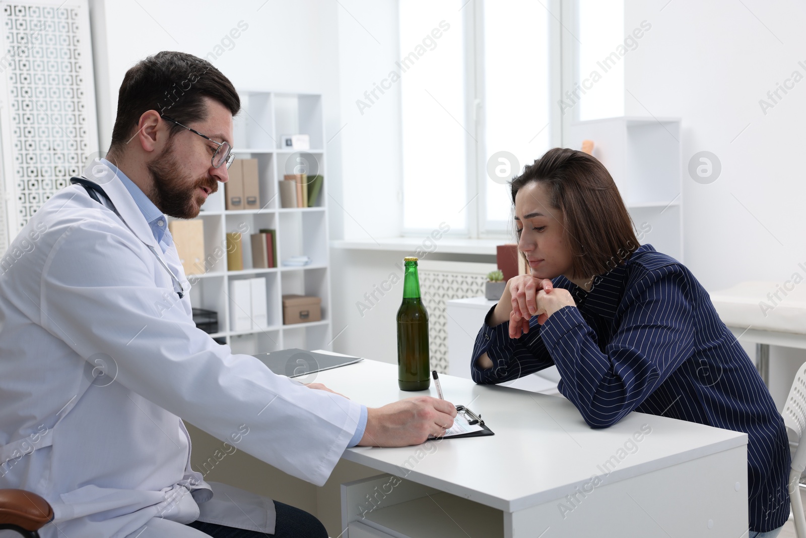 Photo of Alcoholic woman having appointment with healthcare specialist in clinic. Addiction treatment