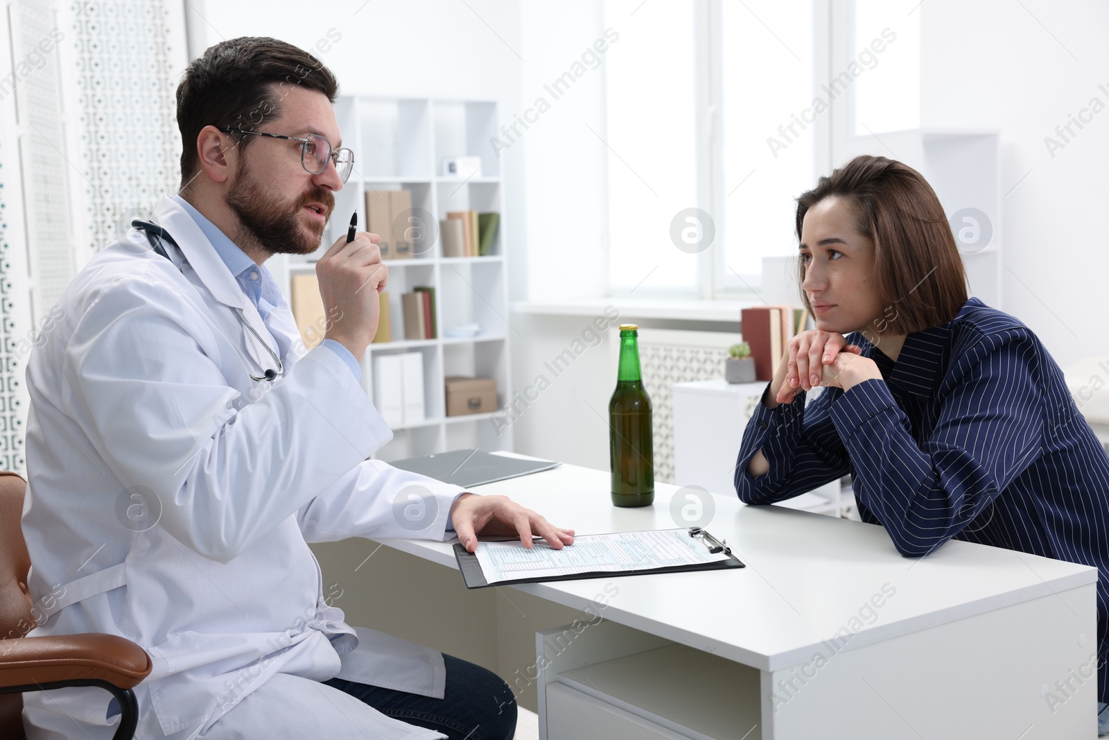 Photo of Alcoholic woman having appointment with healthcare specialist in clinic. Addiction treatment