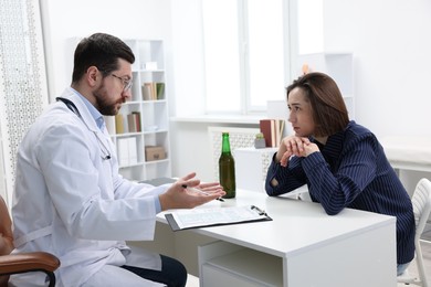 Photo of Alcoholic woman having appointment with healthcare specialist in clinic. Addiction treatment