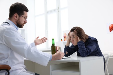 Photo of Alcoholic woman having appointment with healthcare specialist in clinic. Addiction treatment