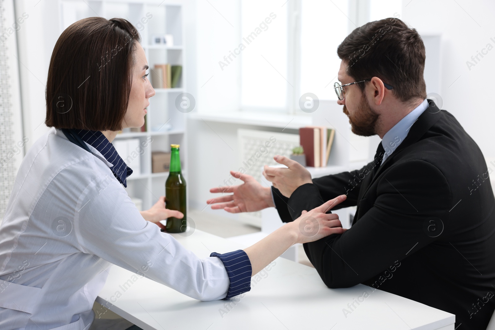 Photo of Alcoholic man having appointment with healthcare specialist in clinic. Addiction treatment