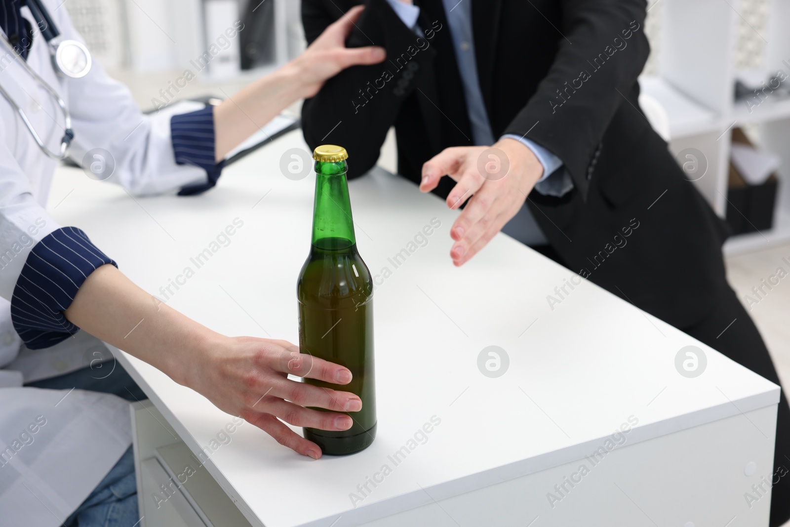 Photo of Alcoholic man having appointment with healthcare specialist in clinic, closeup. Addiction treatment