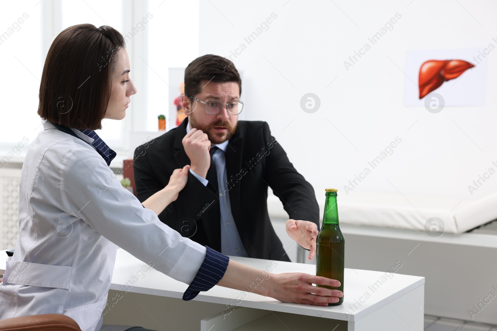 Photo of Alcoholic man having appointment with healthcare specialist in clinic. Addiction treatment