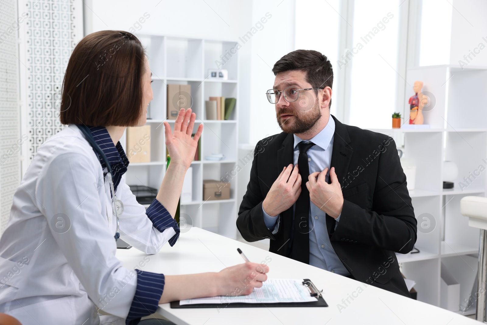 Photo of Alcoholic man having appointment with healthcare specialist in clinic. Addiction treatment