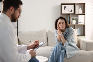 Photo of Alcoholic woman having appointment with healthcare specialist in clinic. Addiction treatment