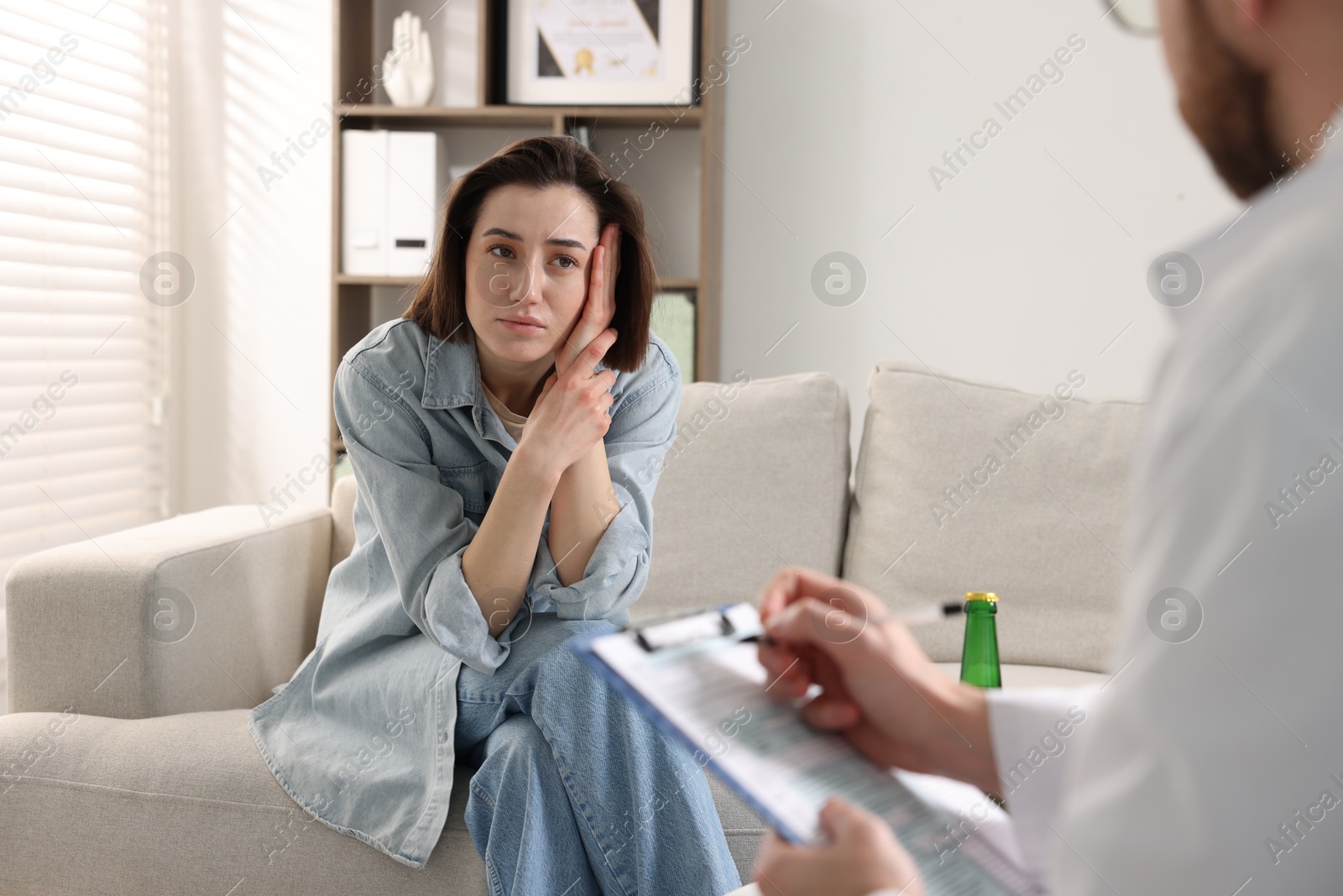 Photo of Alcoholic woman having appointment with healthcare specialist in clinic. Addiction treatment