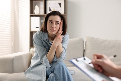 Photo of Alcoholic woman having appointment with healthcare specialist in clinic. Addiction treatment