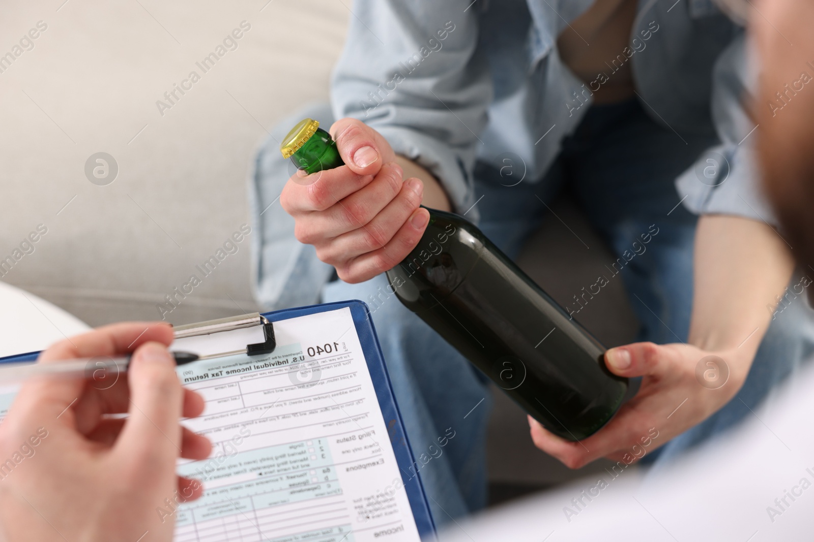 Photo of Alcoholic woman having appointment with healthcare specialist in clinic, closeup. Addiction treatment