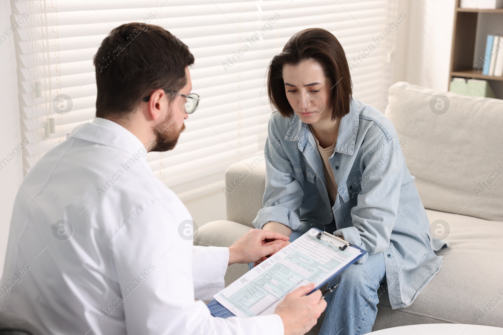 Photo of Alcoholic woman having appointment with healthcare specialist in clinic. Addiction treatment