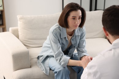 Photo of Alcoholic woman having appointment with healthcare specialist in clinic. Addiction treatment