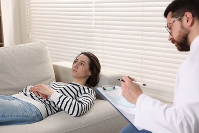 Photo of Alcoholic woman having appointment with healthcare specialist in clinic. Addiction treatment