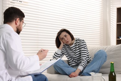 Photo of Alcoholic woman having appointment with healthcare specialist in clinic. Addiction treatment