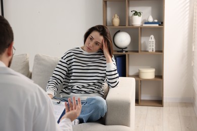 Photo of Alcoholic woman having appointment with healthcare specialist in clinic. Addiction treatment