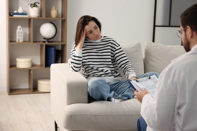 Photo of Alcoholic woman having appointment with healthcare specialist in clinic. Addiction treatment