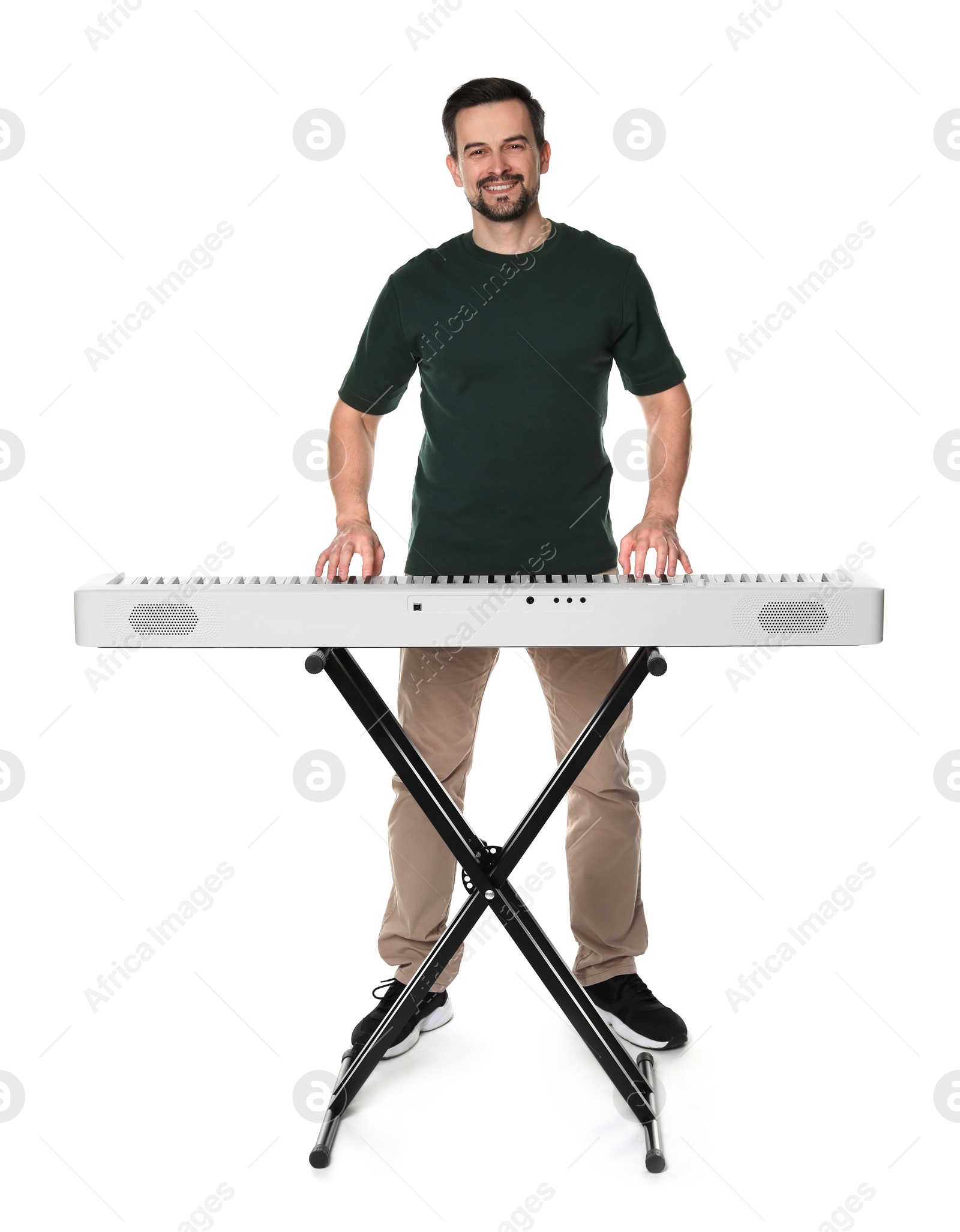 Photo of Smiling man playing synthesizer on white background