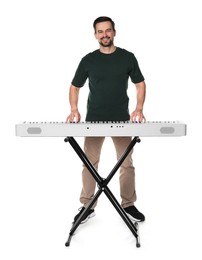 Photo of Smiling man playing synthesizer on white background