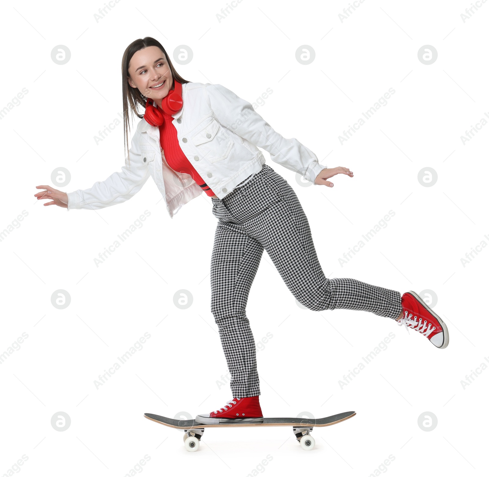 Photo of Smiling woman riding skateboard on white background