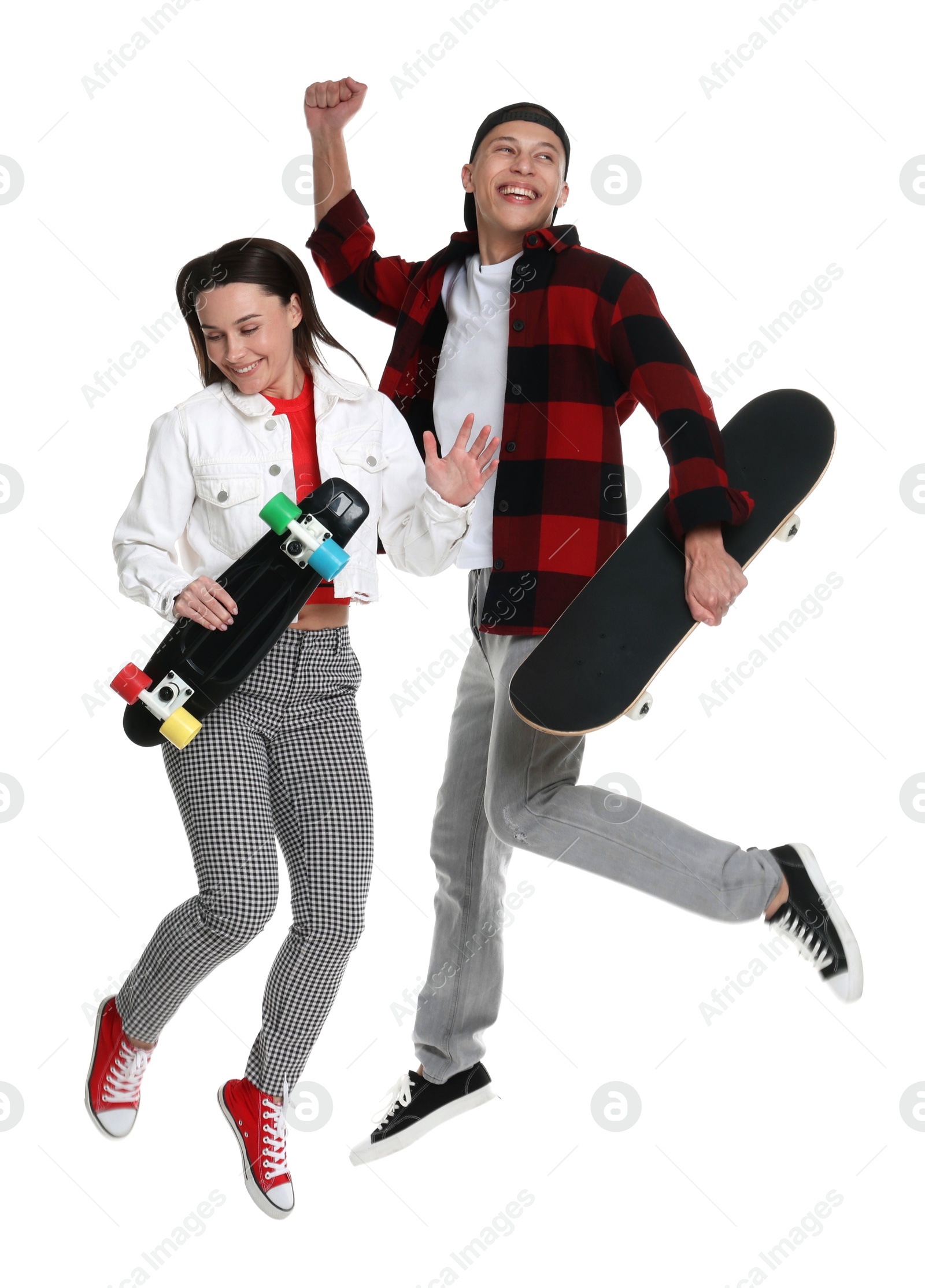 Photo of Happy friends jumping with skateboards on white background