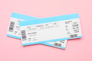 Photo of Travel agency. Flight tickets on pink background, top view