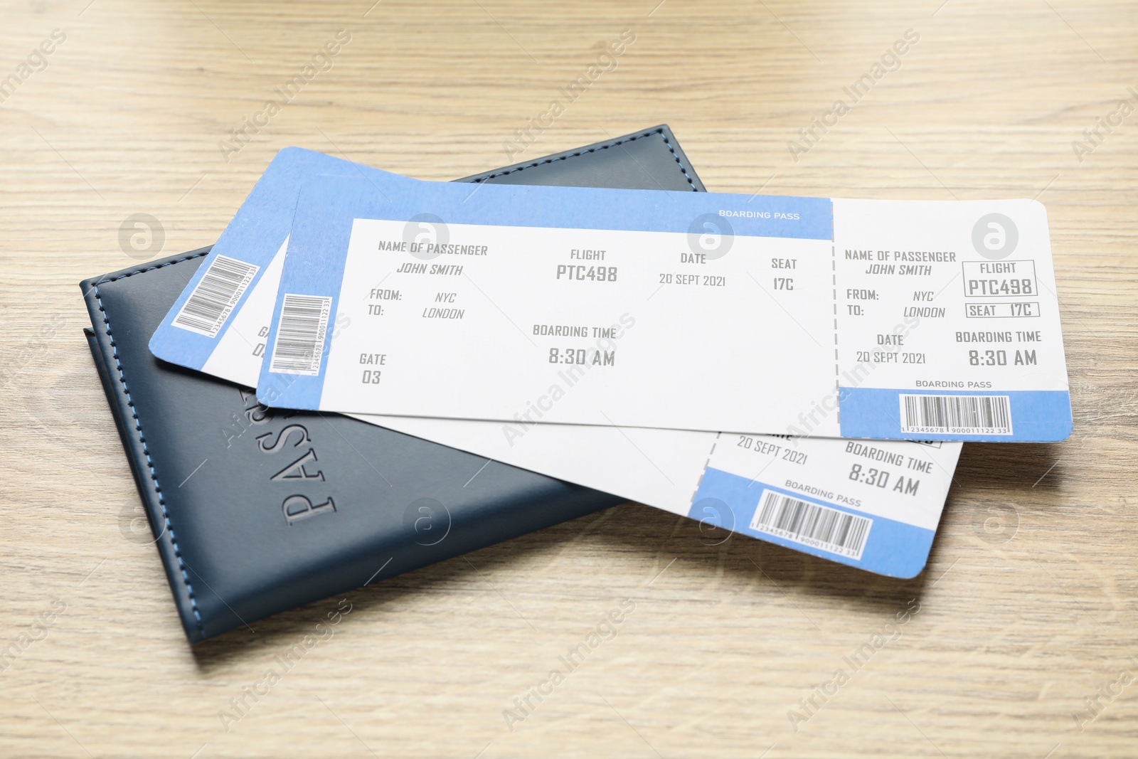 Photo of Travel agency. Flight tickets and passport on wooden table, closeup