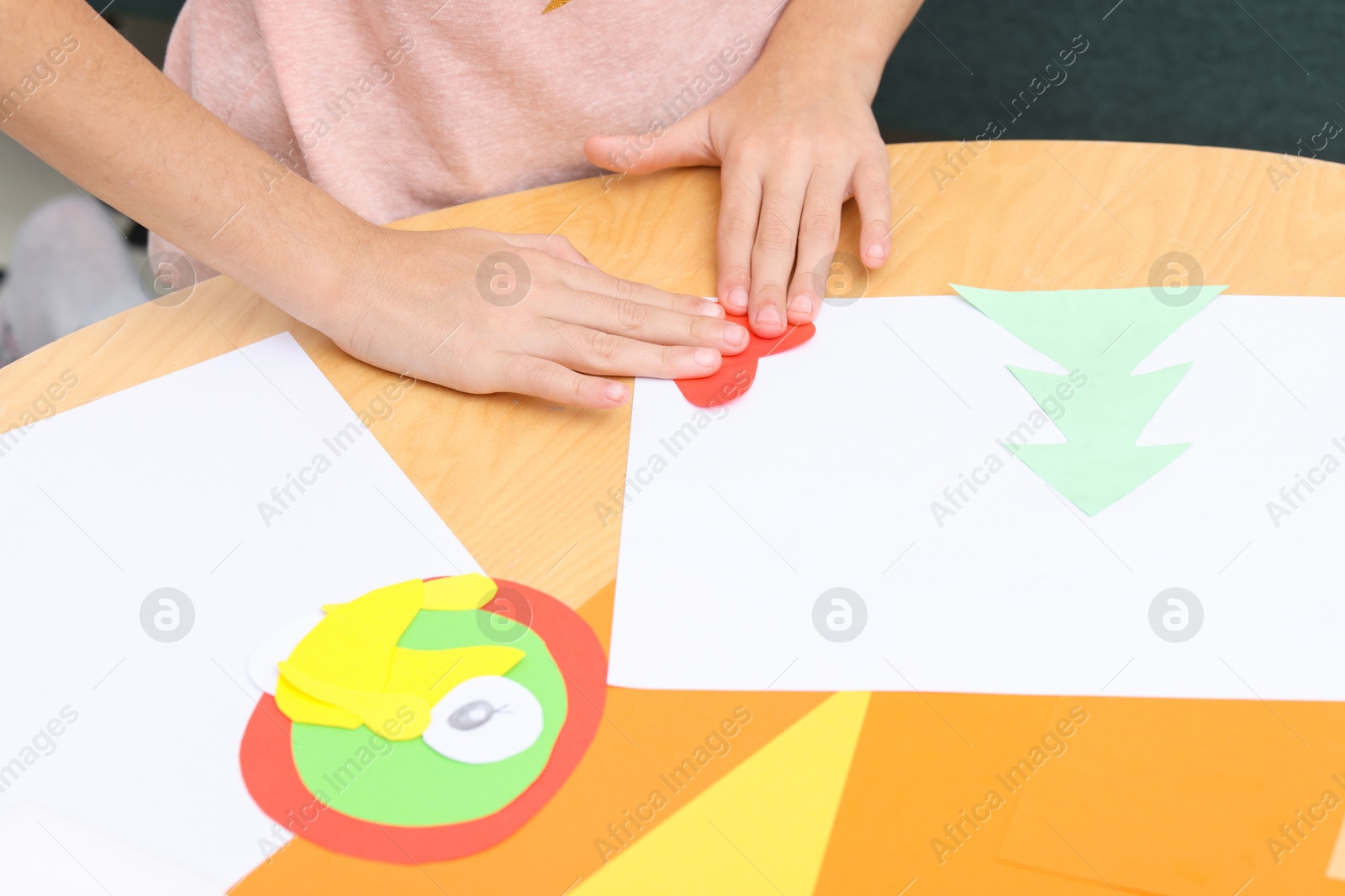 Photo of Girl making art project at table indoors, closeup