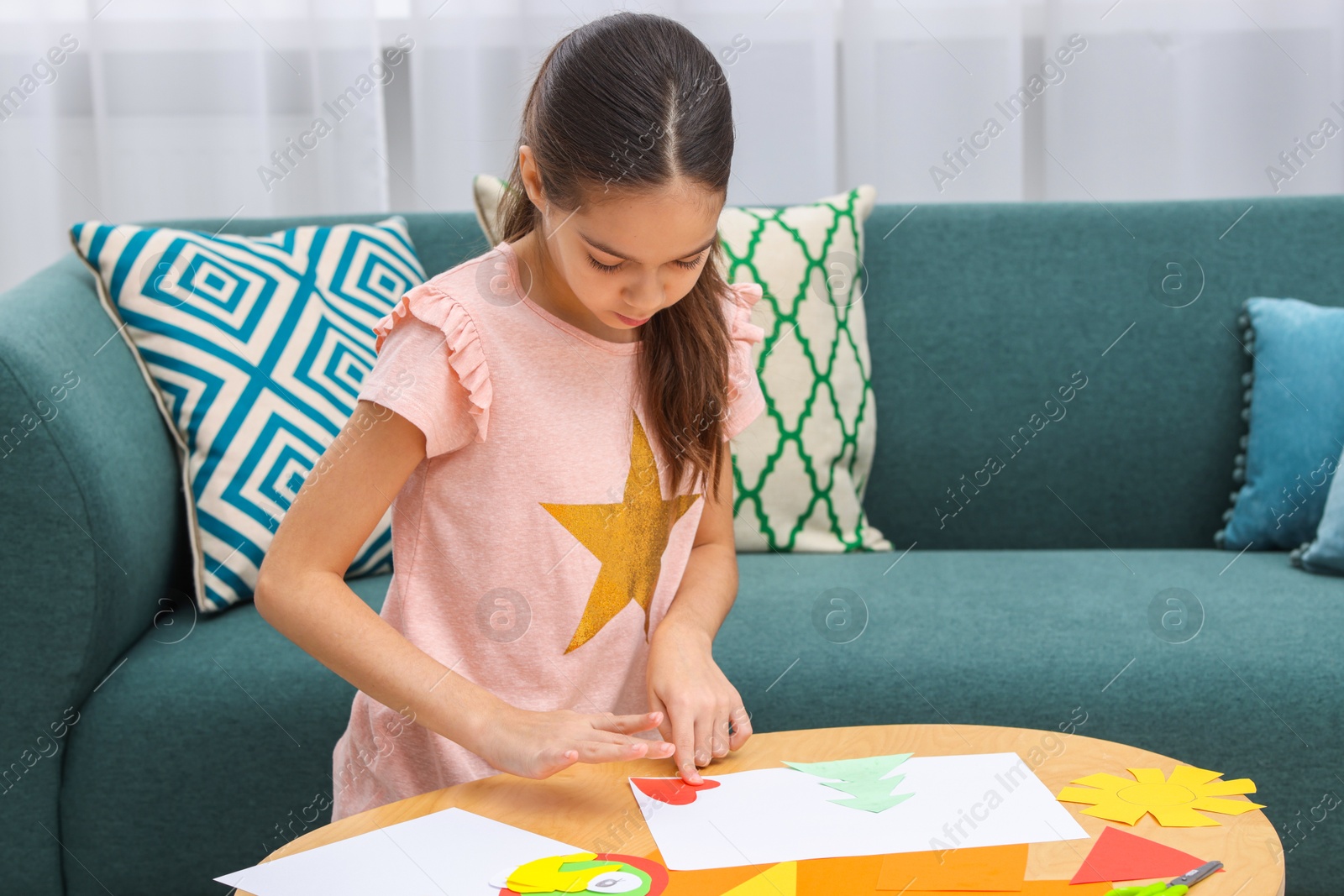 Photo of Girl making art project at table indoors